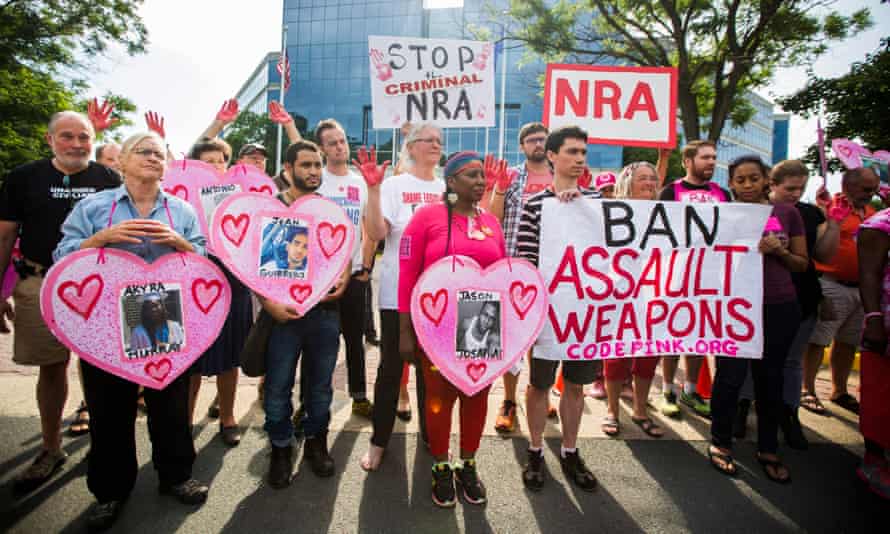 Demonstrators with the activist group CodePink, along with other gun control advocates, hold a protest outside the headquarters of the NRA.