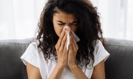 Stock photo of woman blowing runny nose