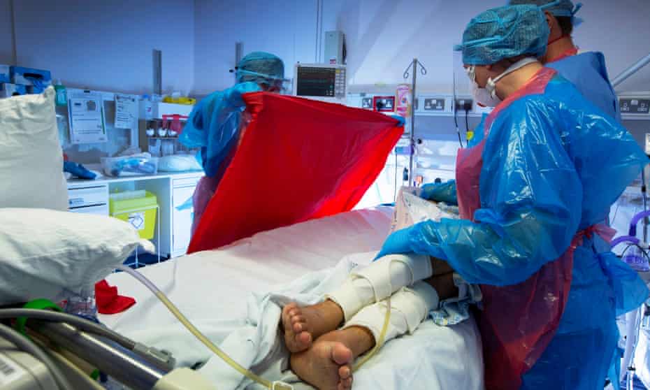 NHS staff bathe a coronavirus patient