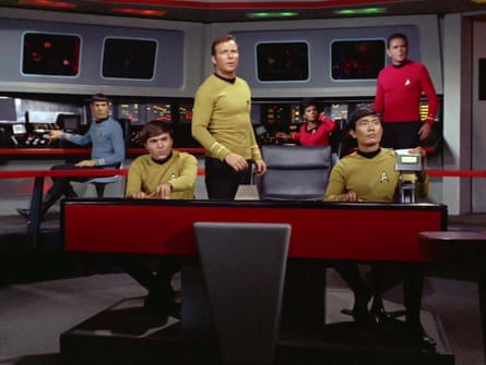 Star Trek’s Enterprise crew, including Kirk and Spock, stand and sit on the bridge