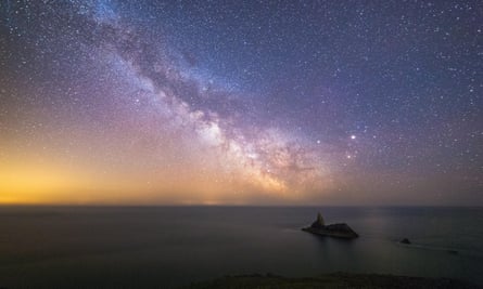 Milky Way streaks across the sky off the coast of Pembrokeshire, Wales.
