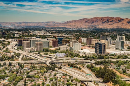 A shot of the skyline of San Jose, with mountains in the background.