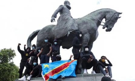 Black Lives Matter protesters with a DR Congo flag on a statue of Leopold II in Brussels 