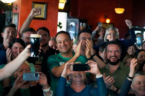 Taoiseach Leo Varadkar (centre) celebrates in Mattie and Eddies bar in Washington, DC, as he watches Ireland win the Six Nations title and the Grand Slam in Dublin after beating England.