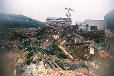 A personification walks among storm-caused debris