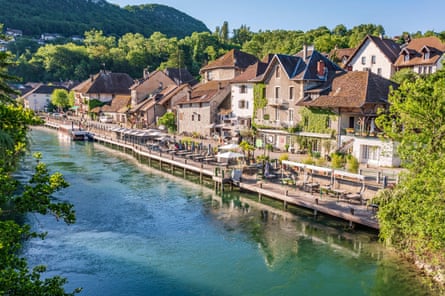 River and old houses, hills and trees.