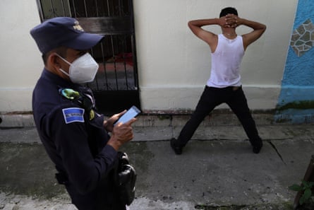 A police officer looks on as they detain someone