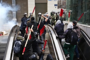 Demonstrators scuffle with riot police