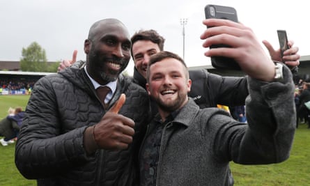 Sol Campbell poses for a selfie with a Macclesfield fan after they stayed up
