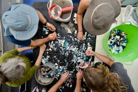 People sort through rubbish from beaches in Tasmania’s wilderness world heritage area
