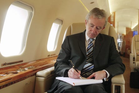 Bernard Arnault writing on a private jet