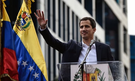 Venezuela’s national assembly head, Juan Guaidó, waves to the crowd during a mass opposition rally n which he declared himself the country’s ‘acting president’.