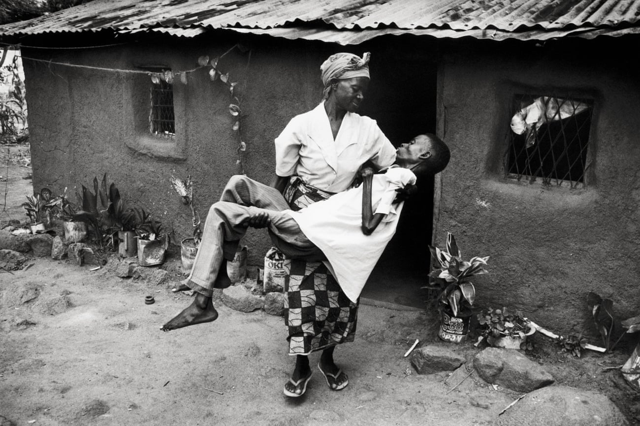 Dorika Gabriel carries her 30-year-old son Joseph to shade, Tanzania,1997.