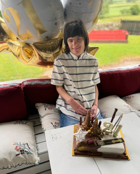 Billy Caldwell celebrates his 21st birthday at home in Northern Ireland with a birthday cake and balloons.
