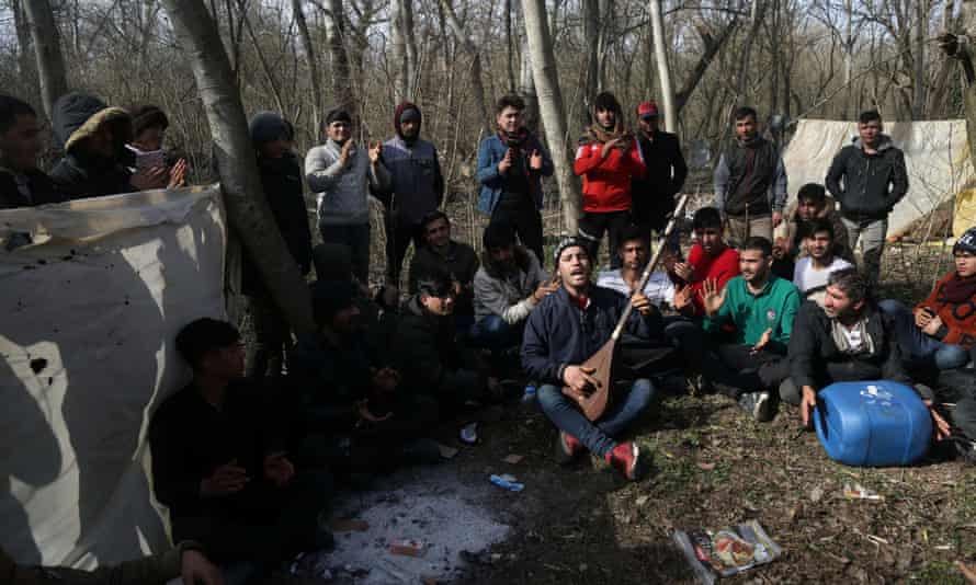Afghan migrants sing as they wait at the Turkish-Greek border in March 2020