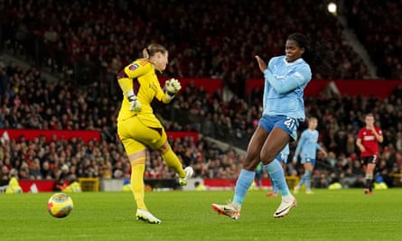 Manchester City’s Khadija Shaw charges down Mary Earps’s clearance to score her side’s third goal.