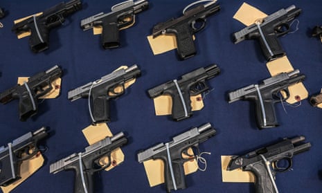 guns on a table in a row