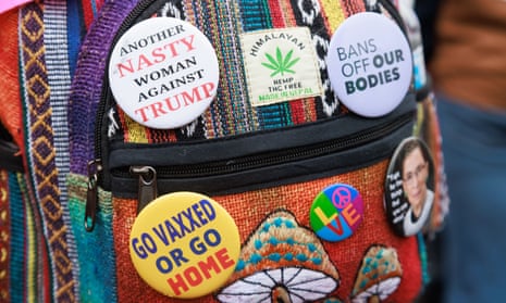 Pins say 'bans off our bodies' and 'another nasty woman against trump'