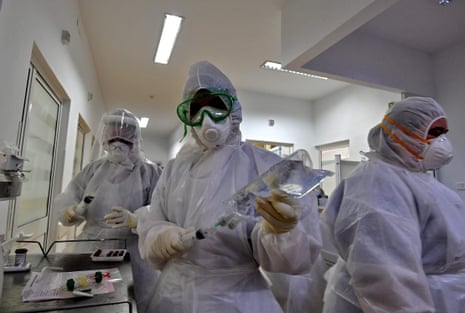 Tunisian medical staff get ready to enter a coronavirus patient area at the intensive care unit of the Ariana Abderrahmen Mami hospital in the city of Ariana near the Tunisian capital Tunis on 27 January, 2021, during the Covid-19 pandemic crisis.