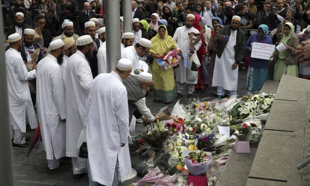 People lay flowers after a vigil for victims of Saturday’s attack in London Bridge, at Potter’s Field Park in London,