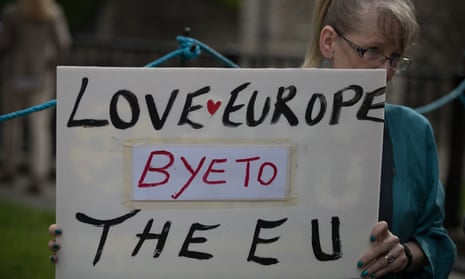 A woman holds up a poster saying farewell to the European Union following Britain’s vote to leave.
