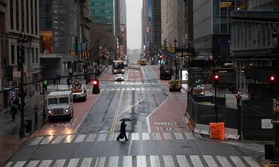 A commuter crosses 42nd Street in front of Grand Central Terminal during morning rush hour, Monday in New York.