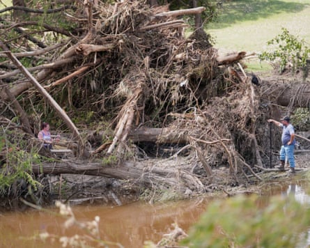 People search along the Guadalupe River after flooding in Kerrville, Texas on Wednesday, July 9, 2025.