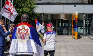 Supporters of Novak Djokovic gather outside the Federal Court building in Melbourne on 10 January where the tennis player is currently appealing in court against the cancellation of his Australian visa.