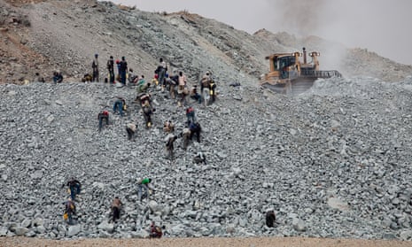 Villagers search for pieces of gold contained in discarded waste rock from the North Mara mine.