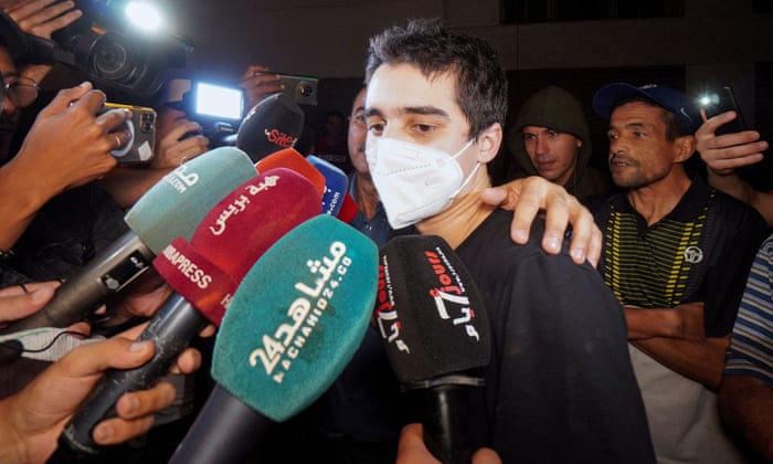 Brahim Saadoun is surrounded by media as he arrives in Casablanca, Morocco