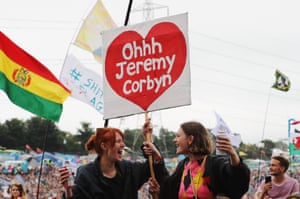 Festivalgoers with a flag supporting Labour party leader Jeremy Corbyn
