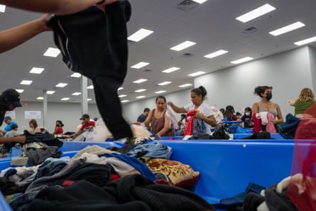 People looking through clothing bins