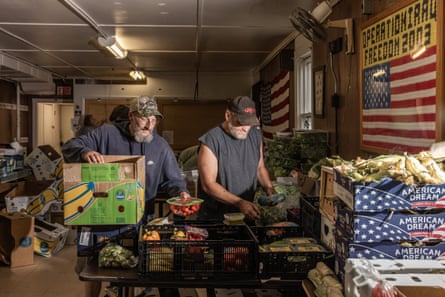 Zeb Maker and Jason Kenney members of Maine Coastal Regional Reentry Center, organize and sort produce.
