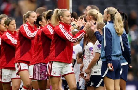 Arsenal and Tottenham players shake hands before kick-off.