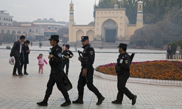 Uighur security personnel patrol near the Id Kah Mosque in Kashgar in western China’s Xinjiang region. 