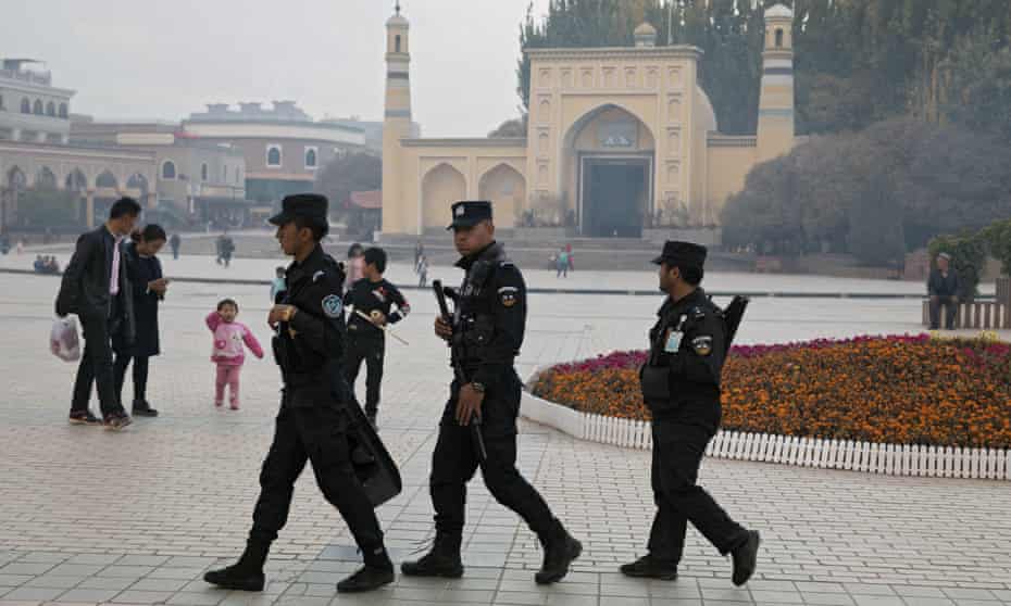 Uighur security personnel patrol near the Id Kah Mosque in Kashgar in western China’s Xinjiang region