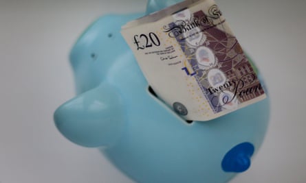 blue piggy bank with £20 notes