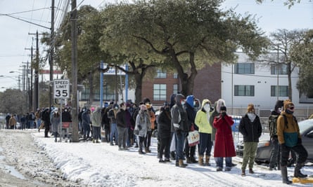 People wait in a long line to buy groceries during an extreme cold snap and widespread power outage on 16 February 2021, in Austin, Texas.