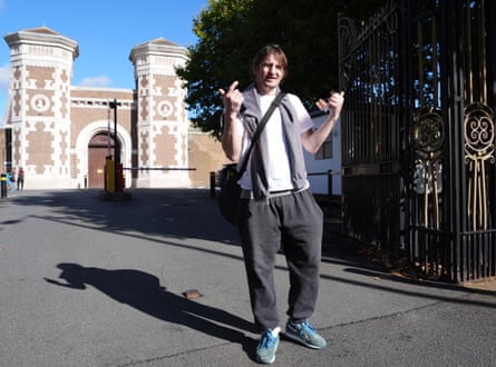 Hudzyk makes a gesture of celebration as he poses with the prison's Victorian entrance behind