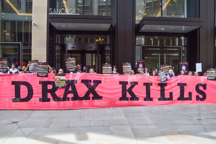 Climate protesters hold up a ‘Drax kills’ banner