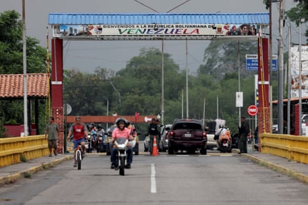 People on motorcyles and in vehicles.