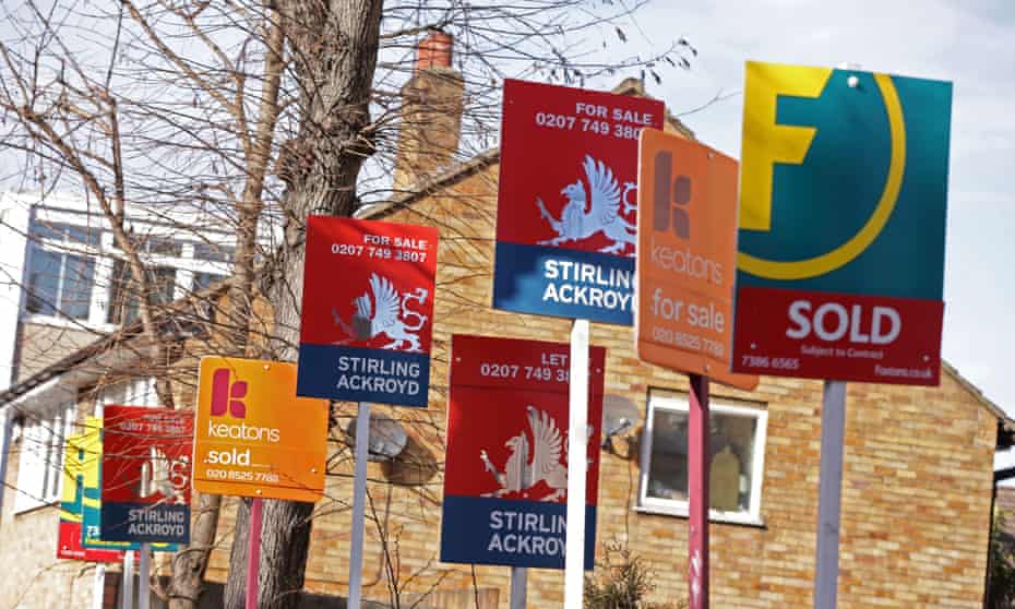 A row of sold, for sale and let by signs displayed outside houses.