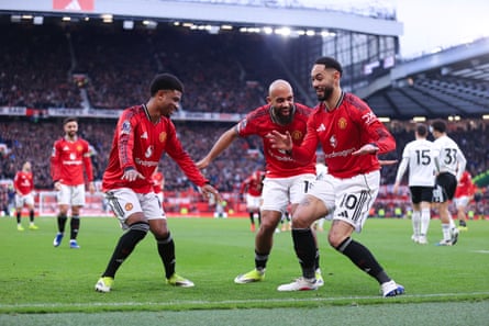 Matheus Cunha of Manchester United celebrates by surfing with teammates.