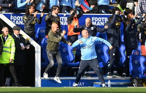 Pep Guardiola celebrates and the Manchester City bench celebrate Kevin De Bruyne rather fine free-kick which gives the visitors the lead.
