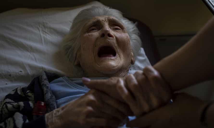An elderly woman who has been evacuated from the Lysychansk area cries moments before departing by train to western Ukraine from the Pokrovsk railway station.