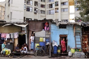 People in Dharavi, India’s largest slum, are seen outside their homes during the lockdown to prevent the spread of the coronavirus in Mumbai.