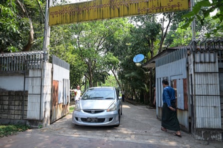 A car leaves the family house of detained Myanmar civilian leader Aung San Suu Kyi