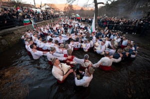 Bulgarian men perform the traditional ‘Horo’ dance in the winter waters of the Tundzha River in the town of Kalofer as part of Epiphany Day celebrations