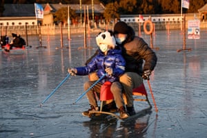 Beijing, China. People on a sledge on a frozen lake at the Summer Palace
