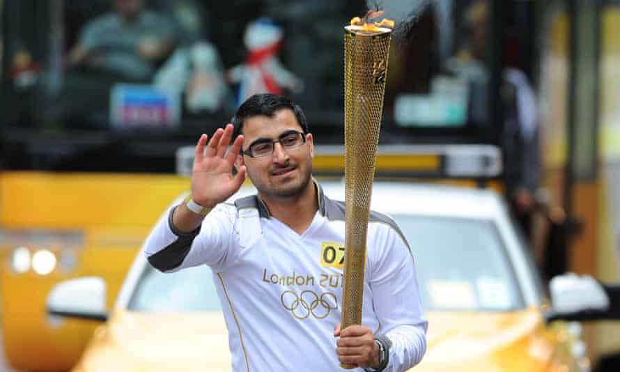 Gulwali carries the Olympic torch in Burnley in June 2012.